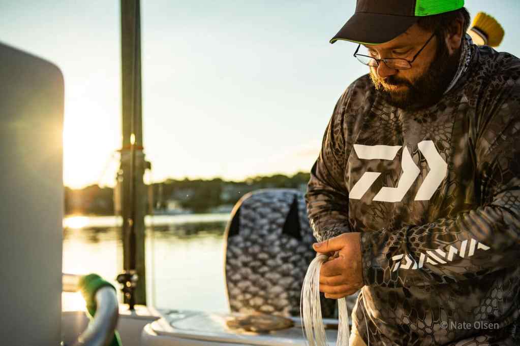 Captain Phillip Durfee preparing tackle aboard Fish Happens